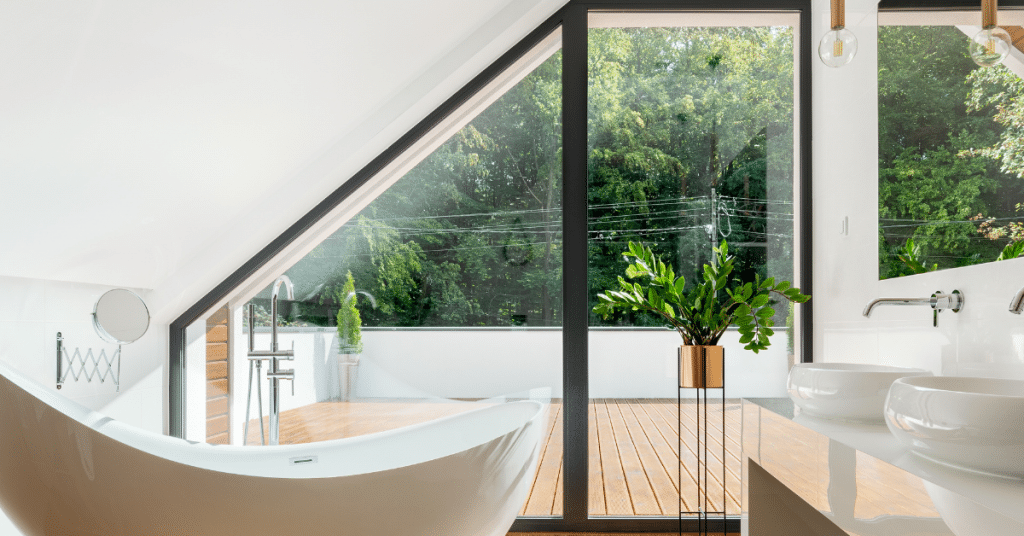 a bathroom with an outdoor view to a wooden deck