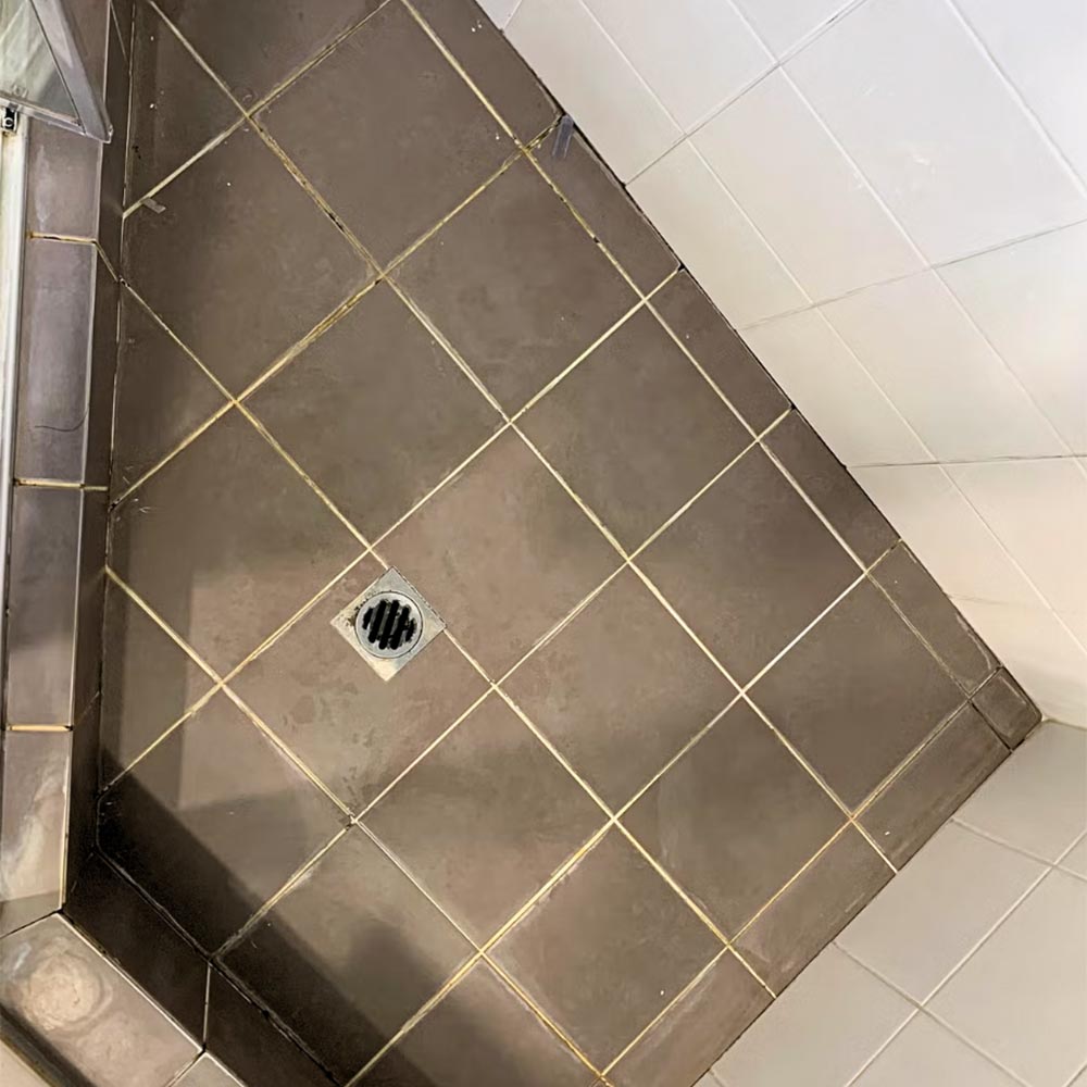 Brown angle shower floor before